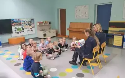 Czytanie bajek dzieciom przez funkcjonariuszki policji.